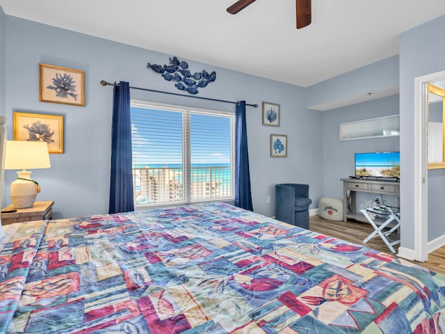 bedroom featuring ceiling fan, baseboards, and wood finished floors