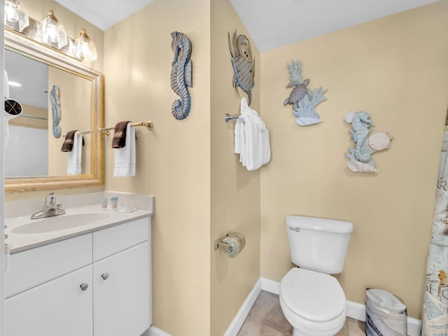 full bath with baseboards, vanity, toilet, and tile patterned floors