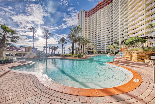 community pool with a patio area