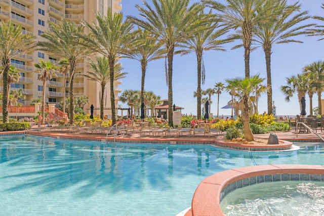 community pool with a hot tub