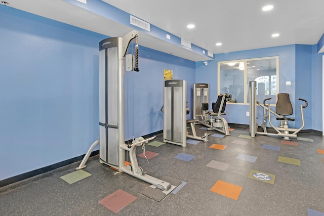 workout area with baseboards, visible vents, and recessed lighting