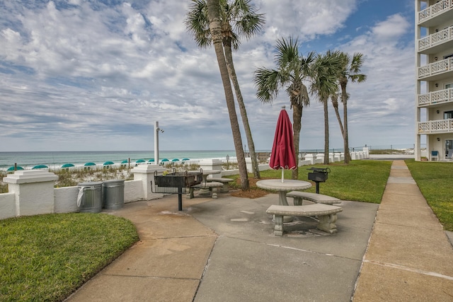 view of patio / terrace featuring a view of the beach and a water view