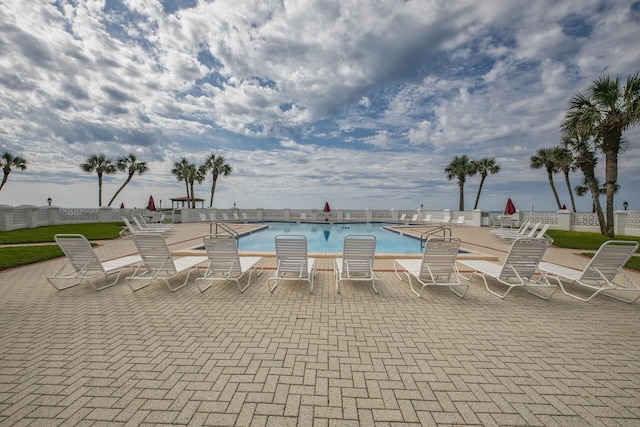 community pool with a patio area