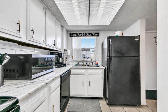 909 Santa Rosa Blvd Unit 537, Fort Walton Beach, FL 32548 - kitchen with light countertops, light tile patterned floors, white cabinets, black appliances, and a sink