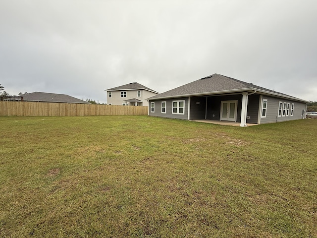 view of yard featuring a patio area, fence, and french doors