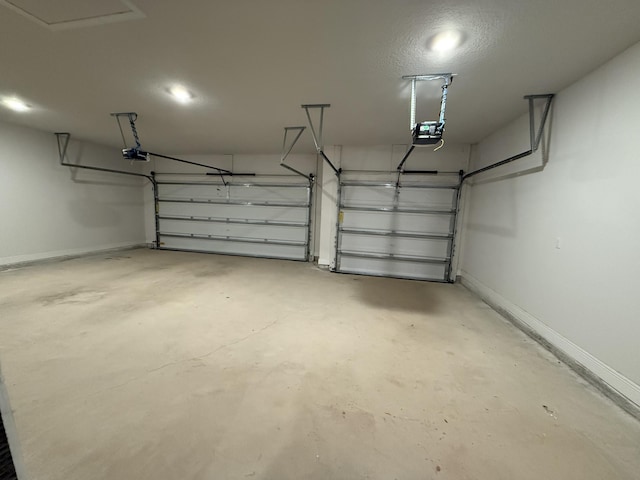 garage with a garage door opener and baseboards