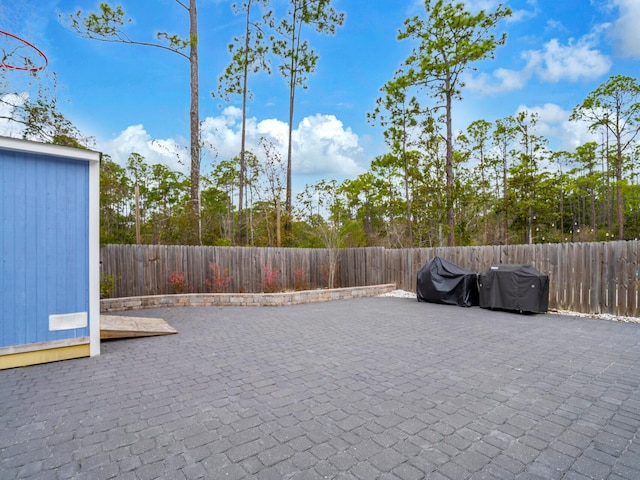 view of patio / terrace featuring a fenced backyard and an outdoor structure