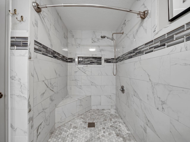 bathroom with a tile shower