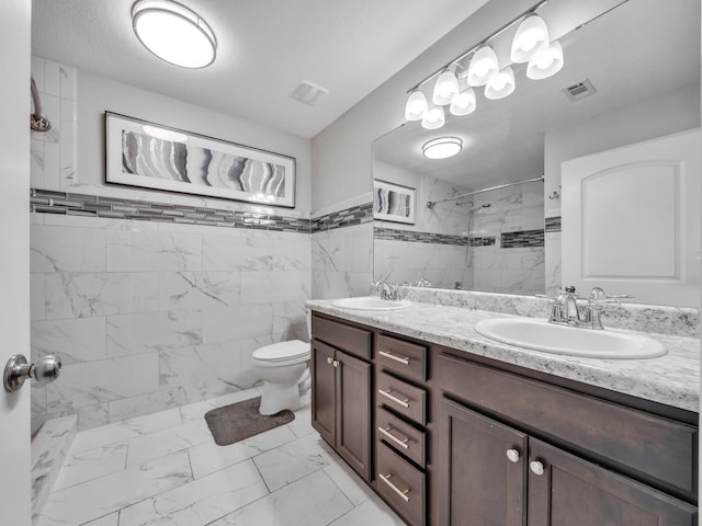 bathroom featuring marble finish floor, a sink, and visible vents