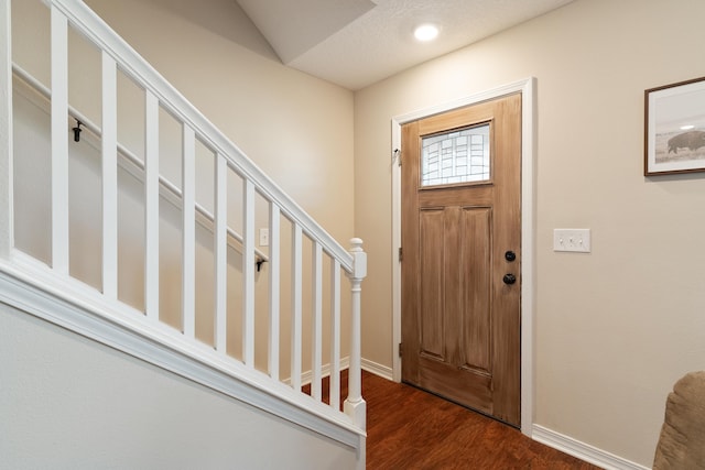 foyer featuring stairs, recessed lighting, wood finished floors, and baseboards