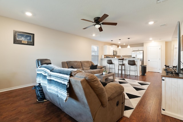 living area with visible vents, ceiling fan, baseboards, recessed lighting, and dark wood-style floors