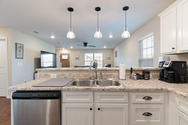 kitchen with stainless steel dishwasher, plenty of natural light, visible vents, and a sink