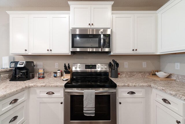 kitchen featuring appliances with stainless steel finishes and white cabinetry