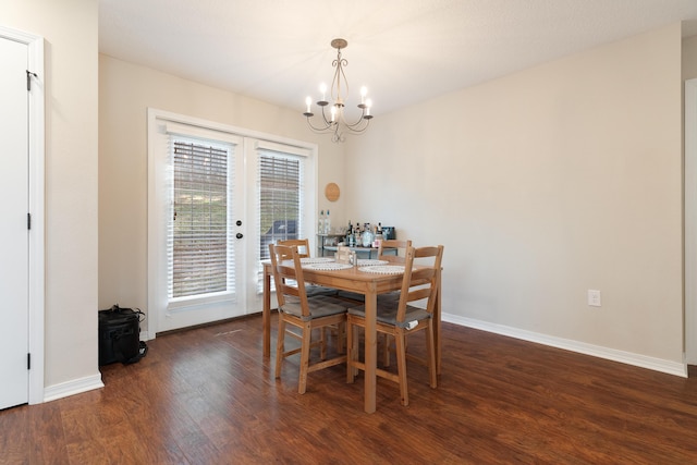 dining area with a notable chandelier, wood finished floors, baseboards, and french doors