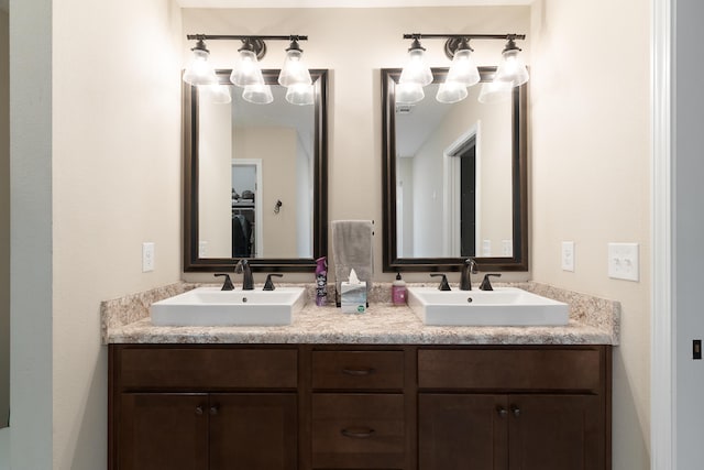 full bathroom featuring double vanity and a sink