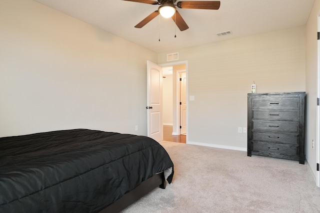 carpeted bedroom featuring visible vents, baseboards, and a ceiling fan