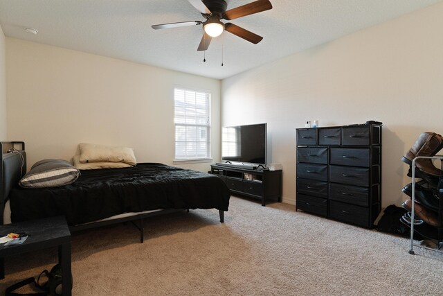 bedroom featuring light carpet and ceiling fan