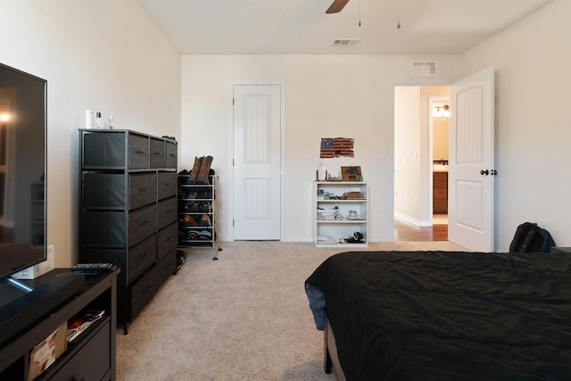 bedroom with visible vents, baseboards, light colored carpet, and a ceiling fan