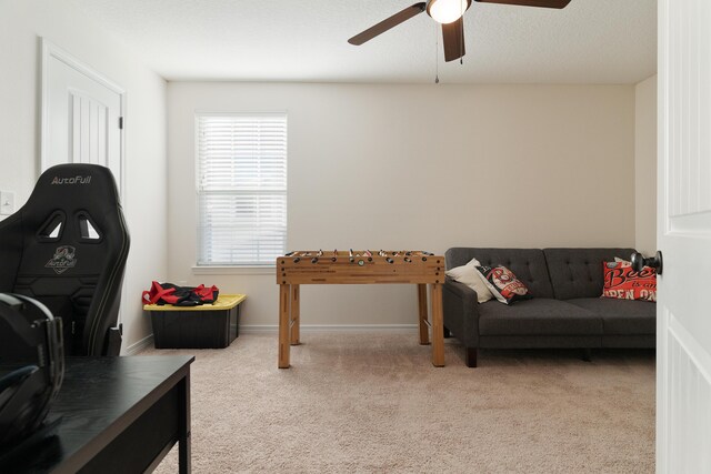 living room with light colored carpet, baseboards, and ceiling fan