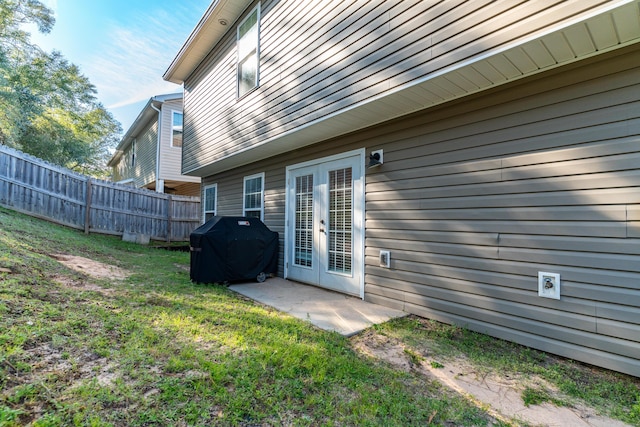 back of house featuring a lawn, french doors, a patio, and fence