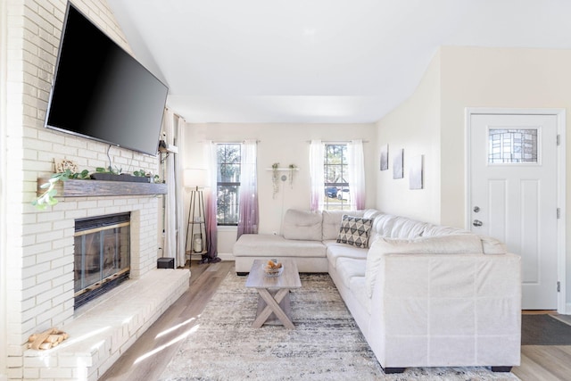 living room with light wood finished floors and a fireplace