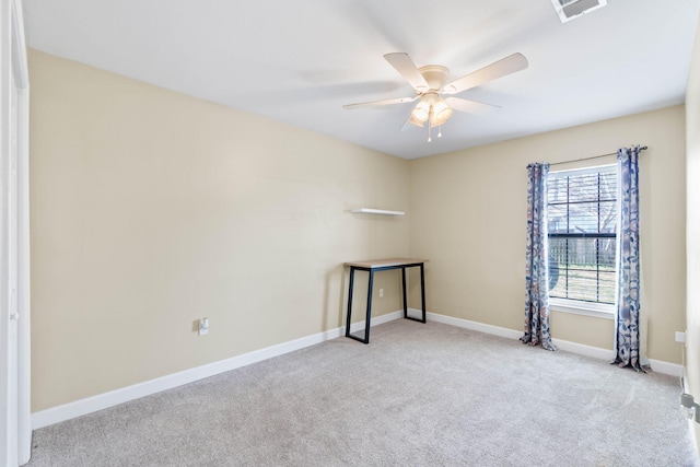 carpeted empty room with baseboards, visible vents, and a ceiling fan