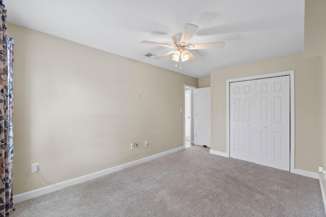 unfurnished bedroom with carpet floors, a closet, visible vents, a ceiling fan, and baseboards