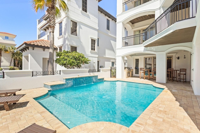 pool with a patio and area for grilling