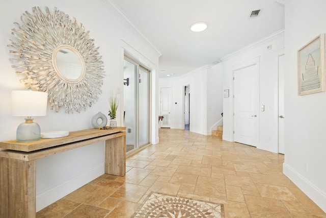 corridor with stone tile floors, visible vents, baseboards, ornamental molding, and stairs