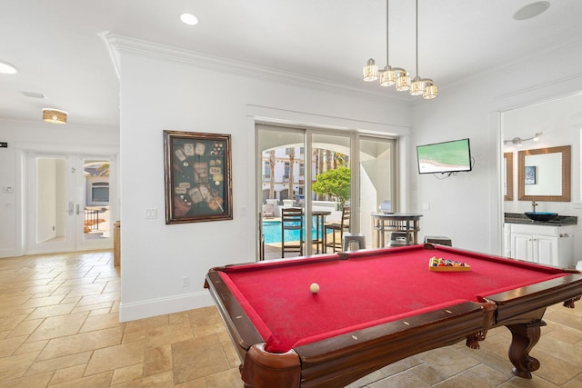 rec room featuring french doors, recessed lighting, stone tile flooring, ornamental molding, and baseboards