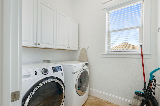 laundry room featuring a healthy amount of sunlight, cabinet space, independent washer and dryer, and baseboards