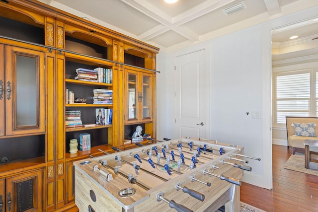 playroom featuring coffered ceiling, visible vents, baseboards, dark wood-style floors, and beamed ceiling