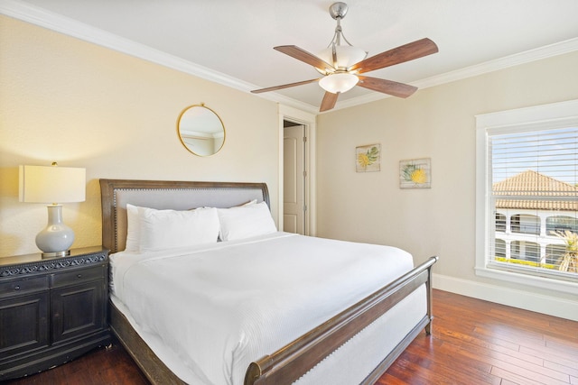 bedroom featuring baseboards, ceiling fan, dark wood-type flooring, and crown molding