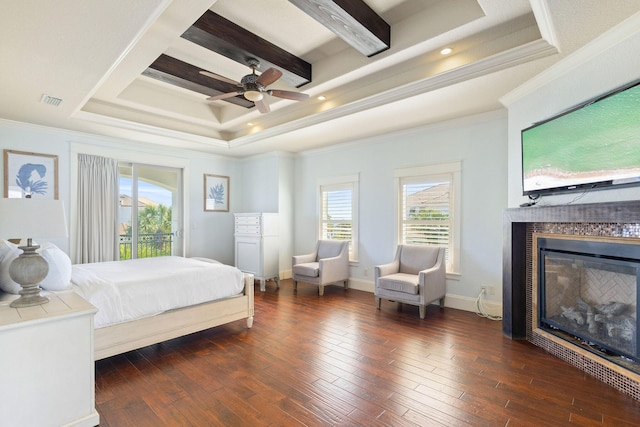 bedroom featuring a tray ceiling, dark wood-type flooring, a glass covered fireplace, beamed ceiling, and baseboards