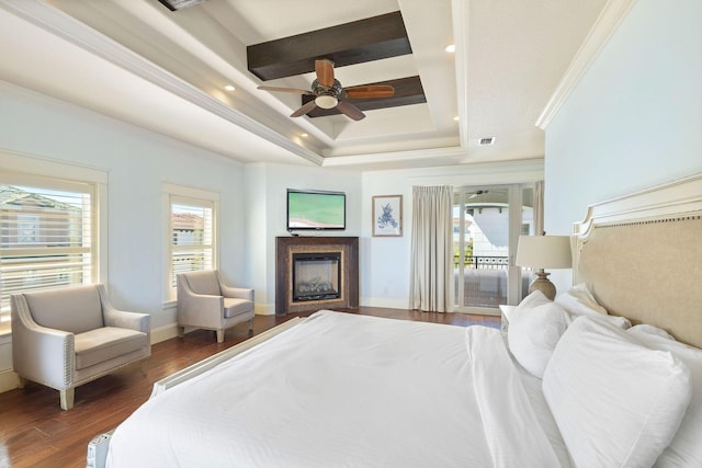 bedroom with access to outside, multiple windows, a fireplace, and dark wood-type flooring