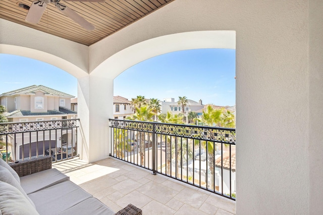 balcony featuring a residential view and a ceiling fan