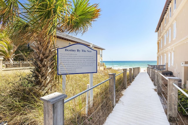 view of home's community with a water view and a view of the beach