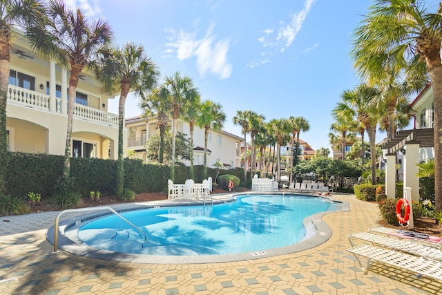 pool featuring a patio area and fence