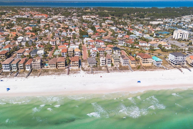 drone / aerial view with a residential view, a view of the beach, and a water view