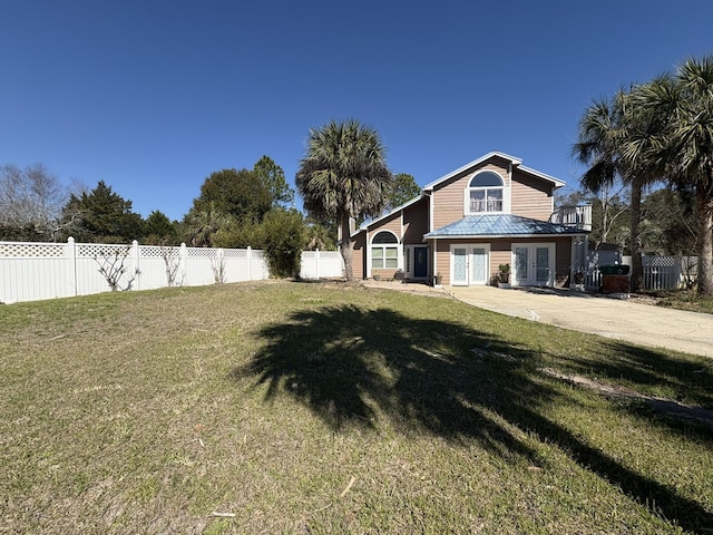 view of yard featuring french doors and a fenced backyard