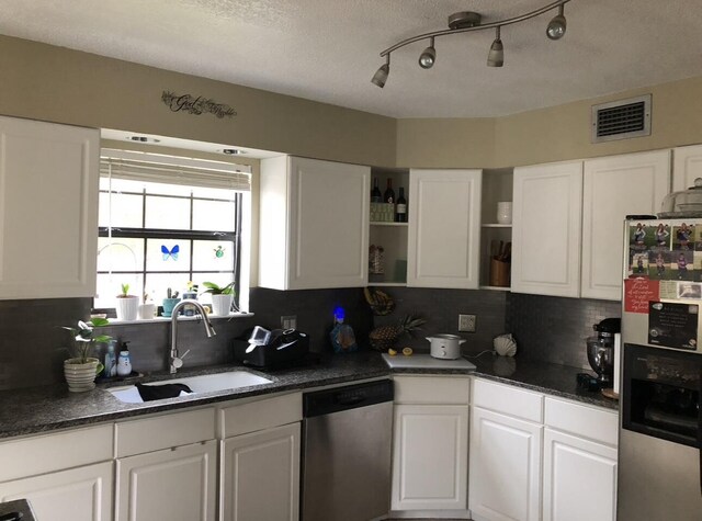 kitchen with visible vents, open shelves, stainless steel appliances, white cabinetry, and a sink