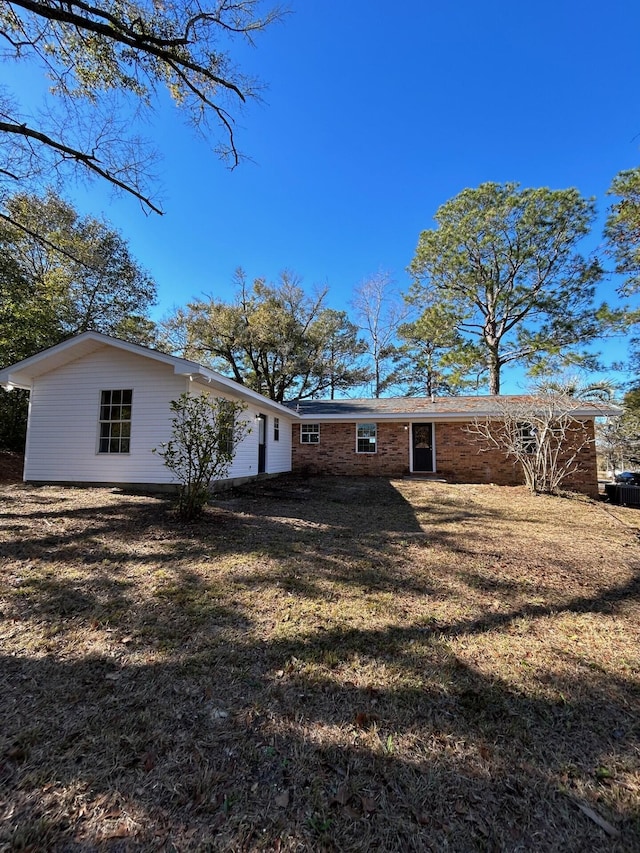 back of property featuring a yard