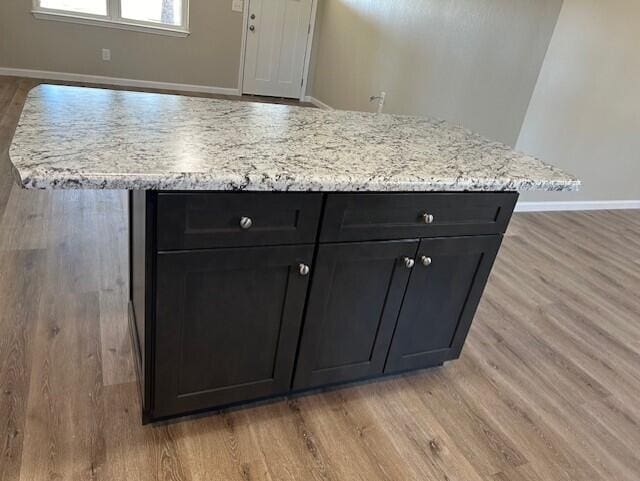 room details featuring baseboards and wood finished floors