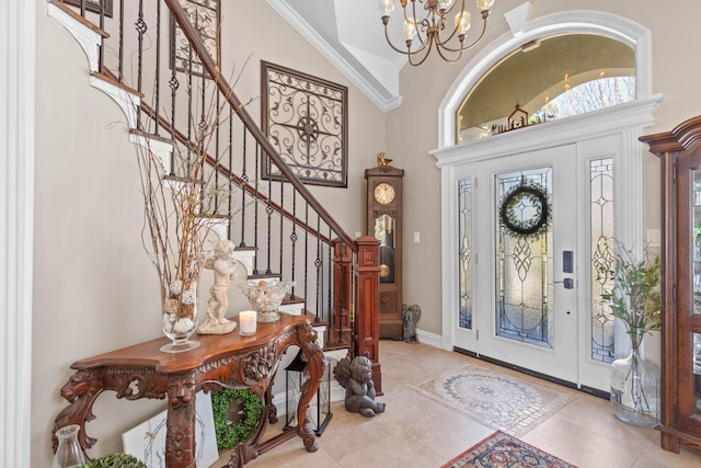 entryway featuring tile patterned flooring, baseboards, a chandelier, stairs, and a high ceiling