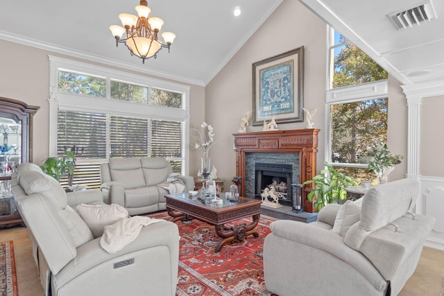 living area with an inviting chandelier, a fireplace with raised hearth, visible vents, and a healthy amount of sunlight