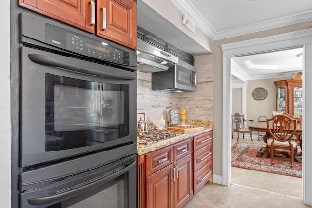 kitchen with light stone counters, light tile patterned flooring, stainless steel appliances, crown molding, and backsplash