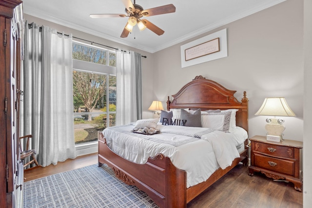 bedroom with wood finished floors, a ceiling fan, and ornamental molding