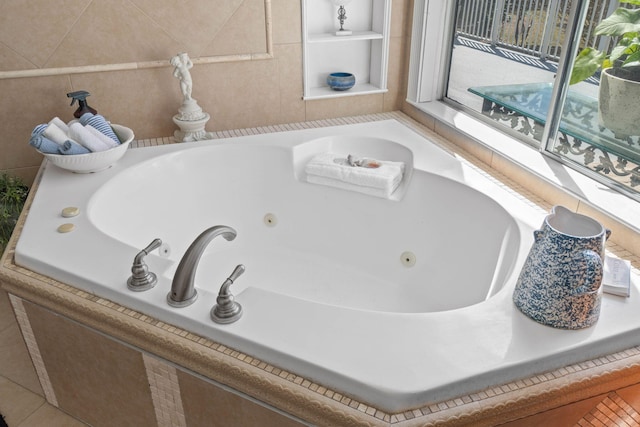 bathroom with tile patterned flooring and a jetted tub