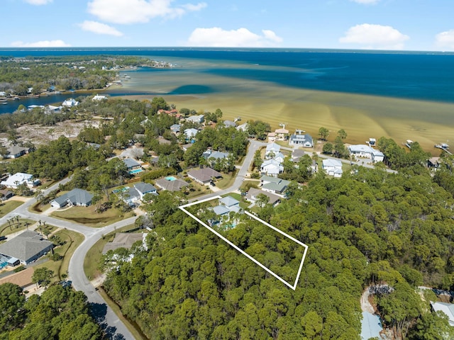 bird's eye view featuring a residential view, a water view, and a view of trees