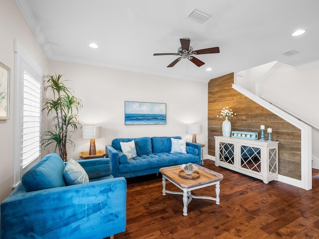 living room with recessed lighting, visible vents, wood finished floors, and ornamental molding